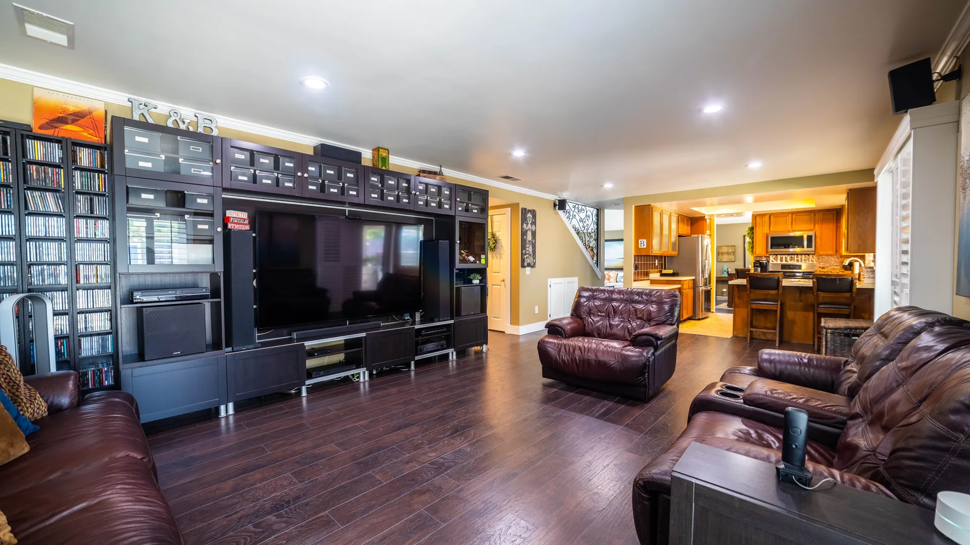 Open-concept living space by North South Construction with custom entertainment built-ins
