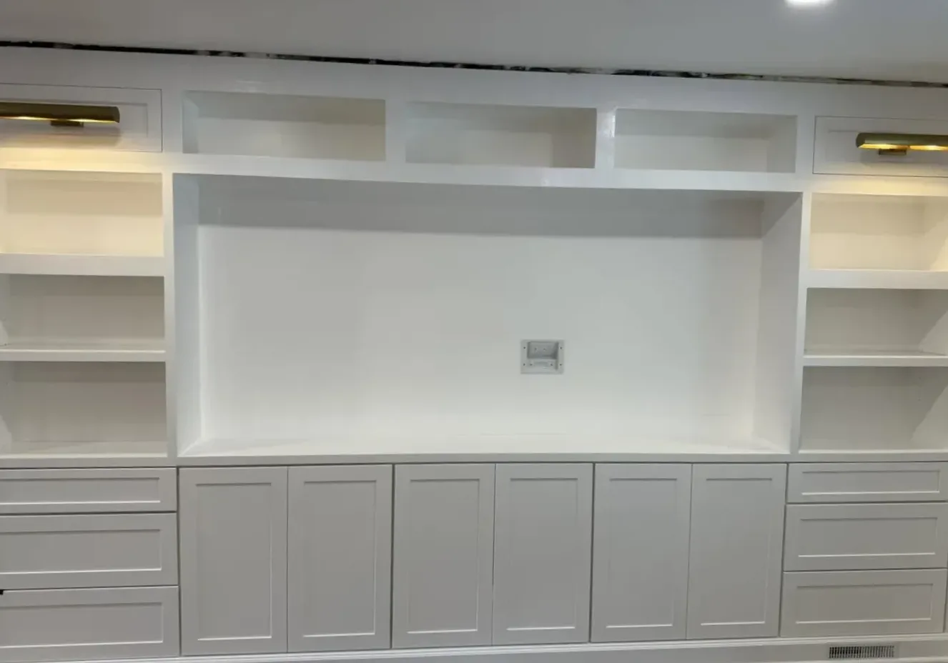 Custom built-in entertainment center with shaker cabinetry by North South Construction